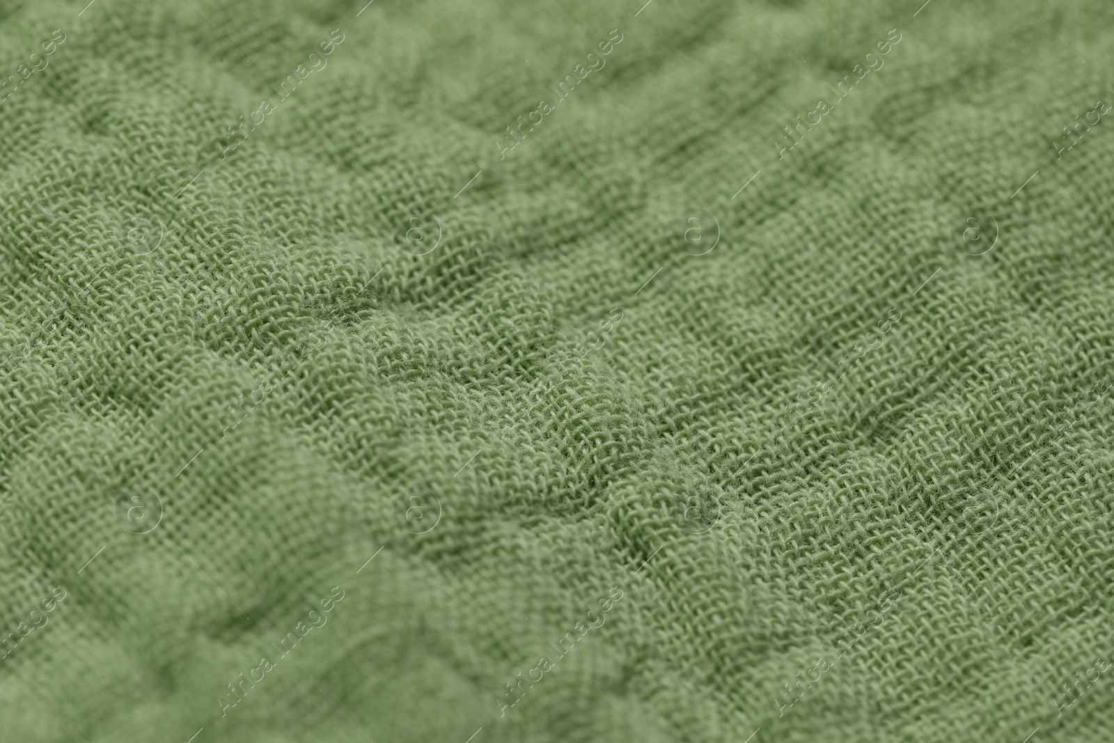 Photo of Texture of soft green fabric as background, closeup