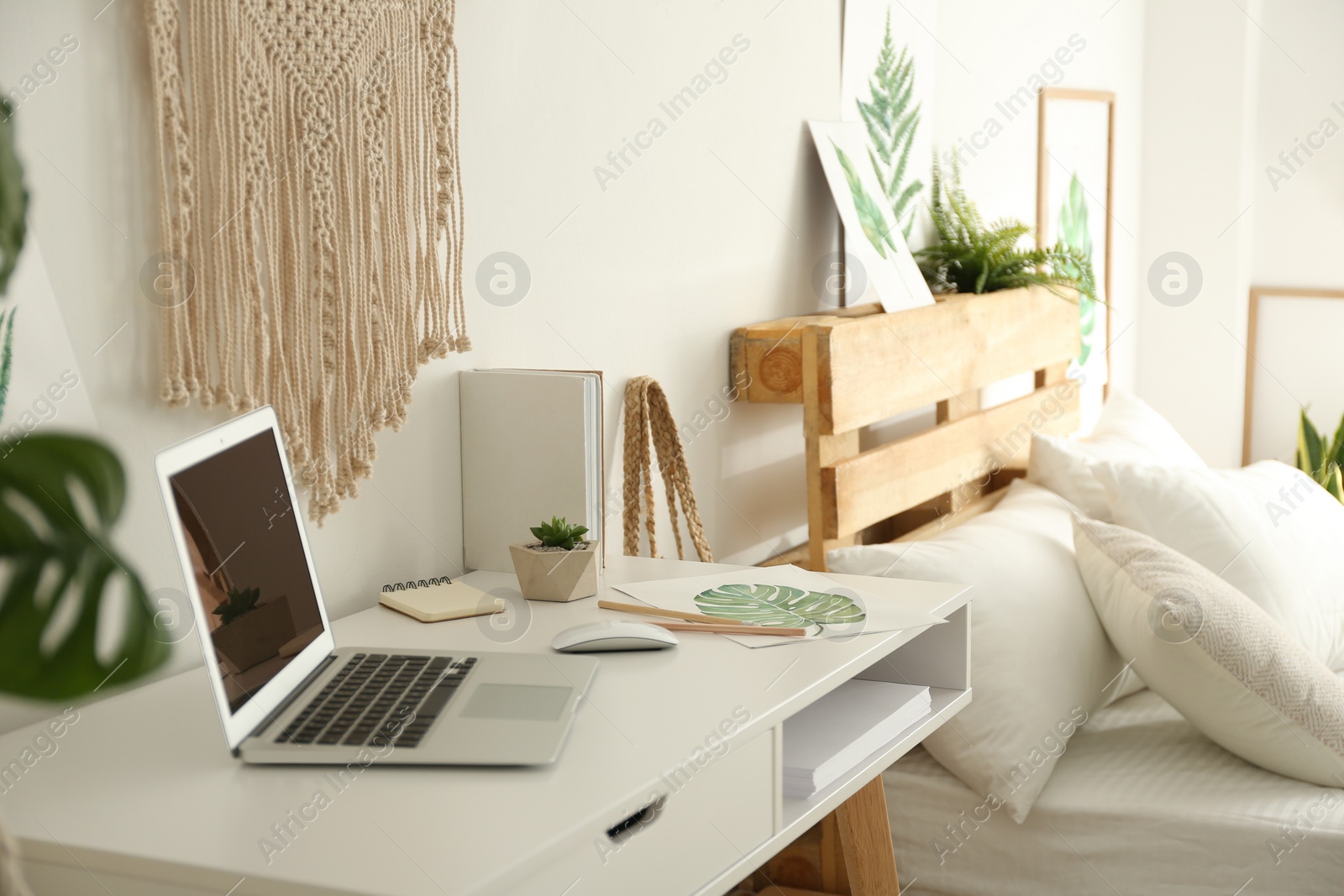 Photo of Stylish room interior with workplace and bed