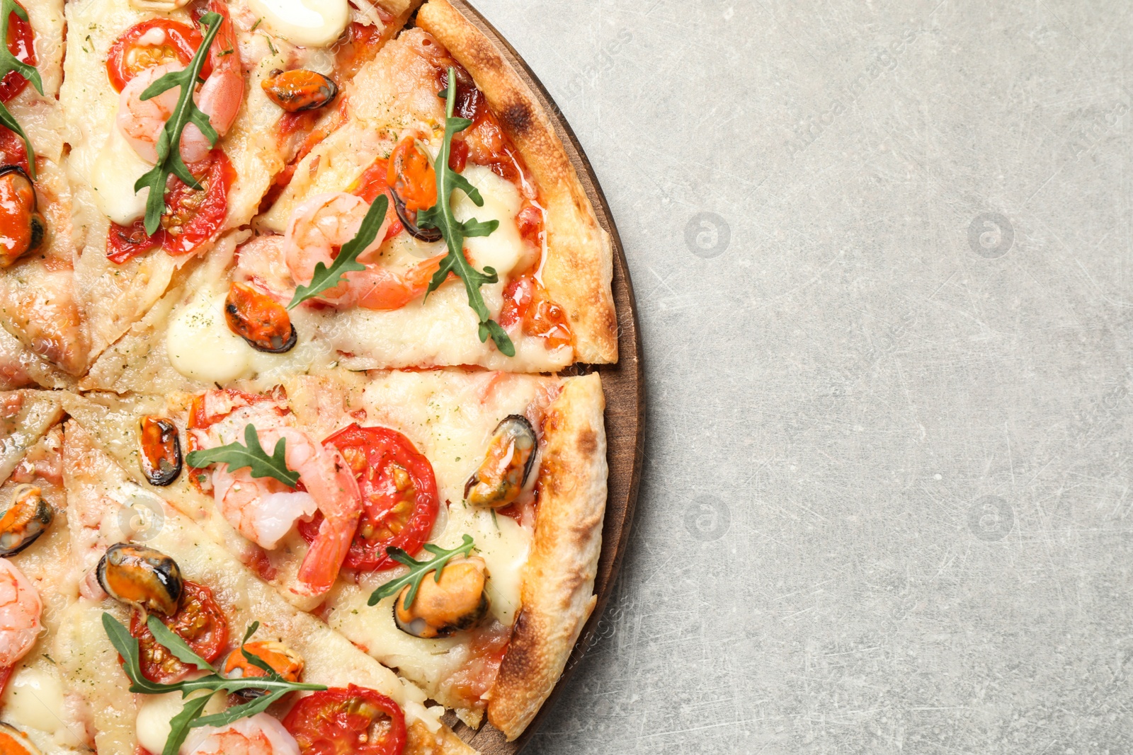 Photo of Delicious seafood pizza on light grey table, top view. Space for text