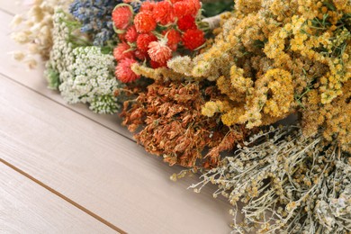 Photo of Different medicinal herbs on wooden table, closeup. Space for text