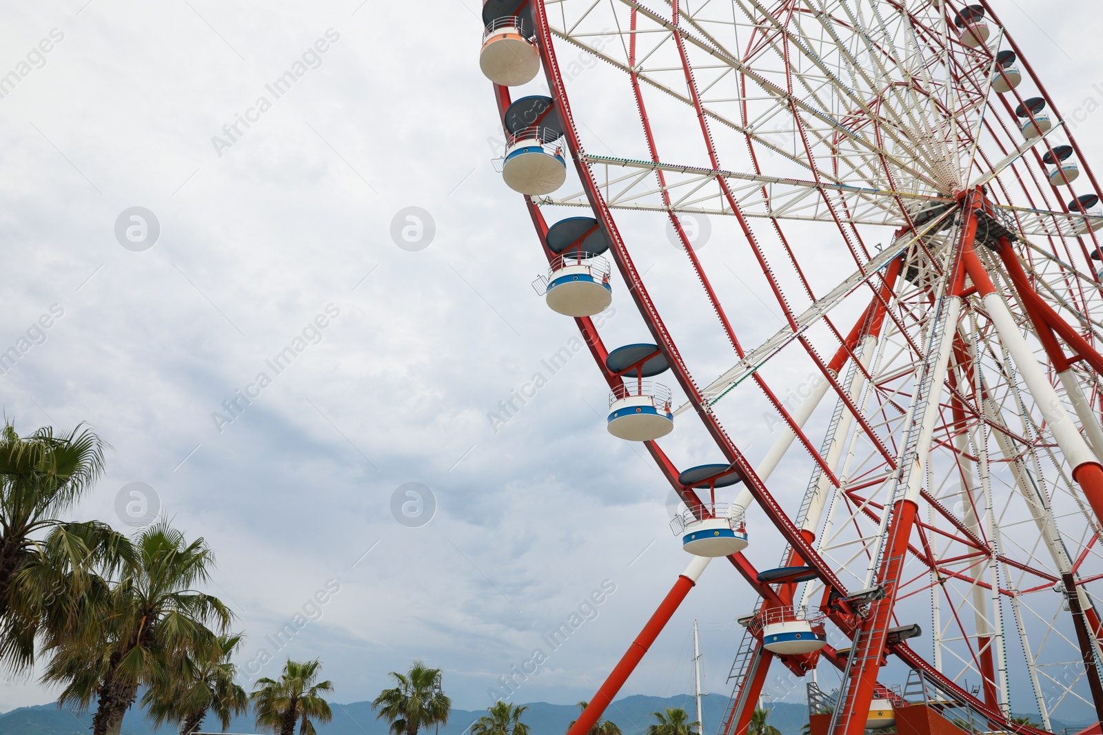 Photo of Beautiful large Ferris wheel outdoors, low angle view