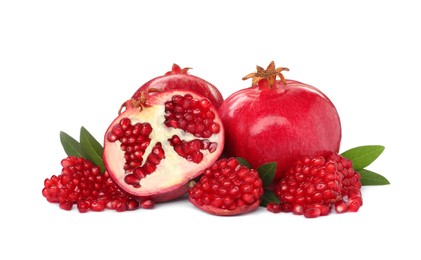 Photo of Tasty ripe pomegranates and leaves on white background