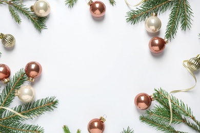 Photo of Frame of Christmas tree branches and festive decoration on white background, top view. Space for text