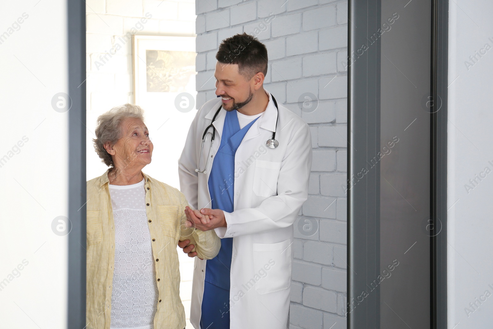 Photo of Doctor with senior patient at modern hospital