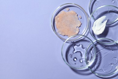 Photo of Flat lay composition with Petri dishes on lilac background. Space for text