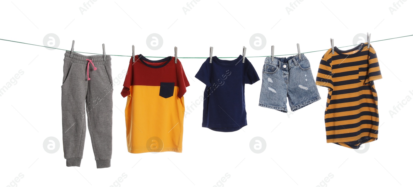 Photo of Different clothes drying on washing line against white background