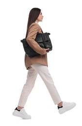 Beautiful businesswoman with briefcase walking on white background