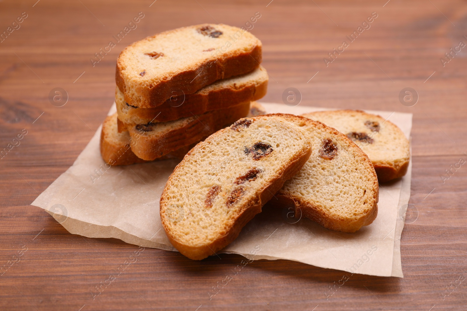 Photo of Sweet hard chuck crackers with raisins on wooden table