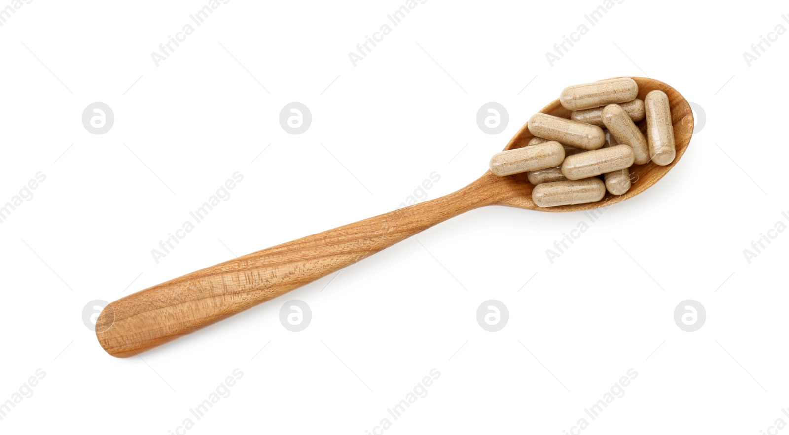 Photo of Vitamin capsules in wooden spoon isolated on white, top view. Health supplement