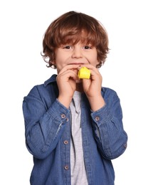 Photo of Birthday celebration. Cute little boy with blower on white background