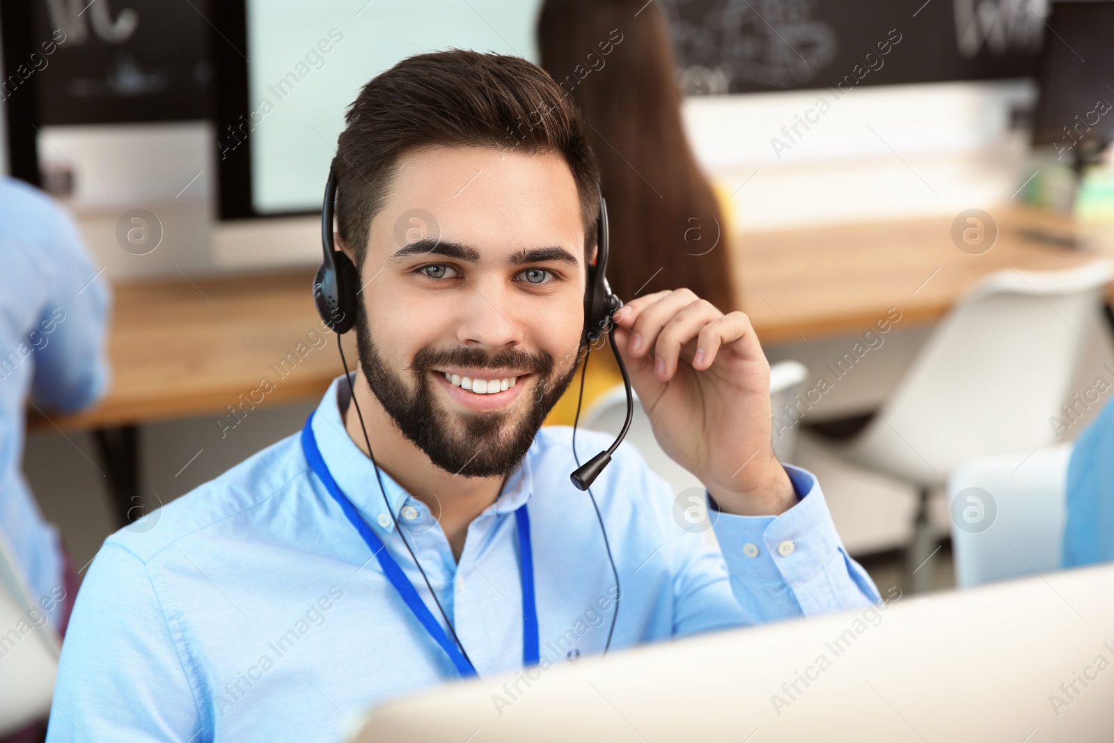 Photo of Technical support operator working with colleagues in office