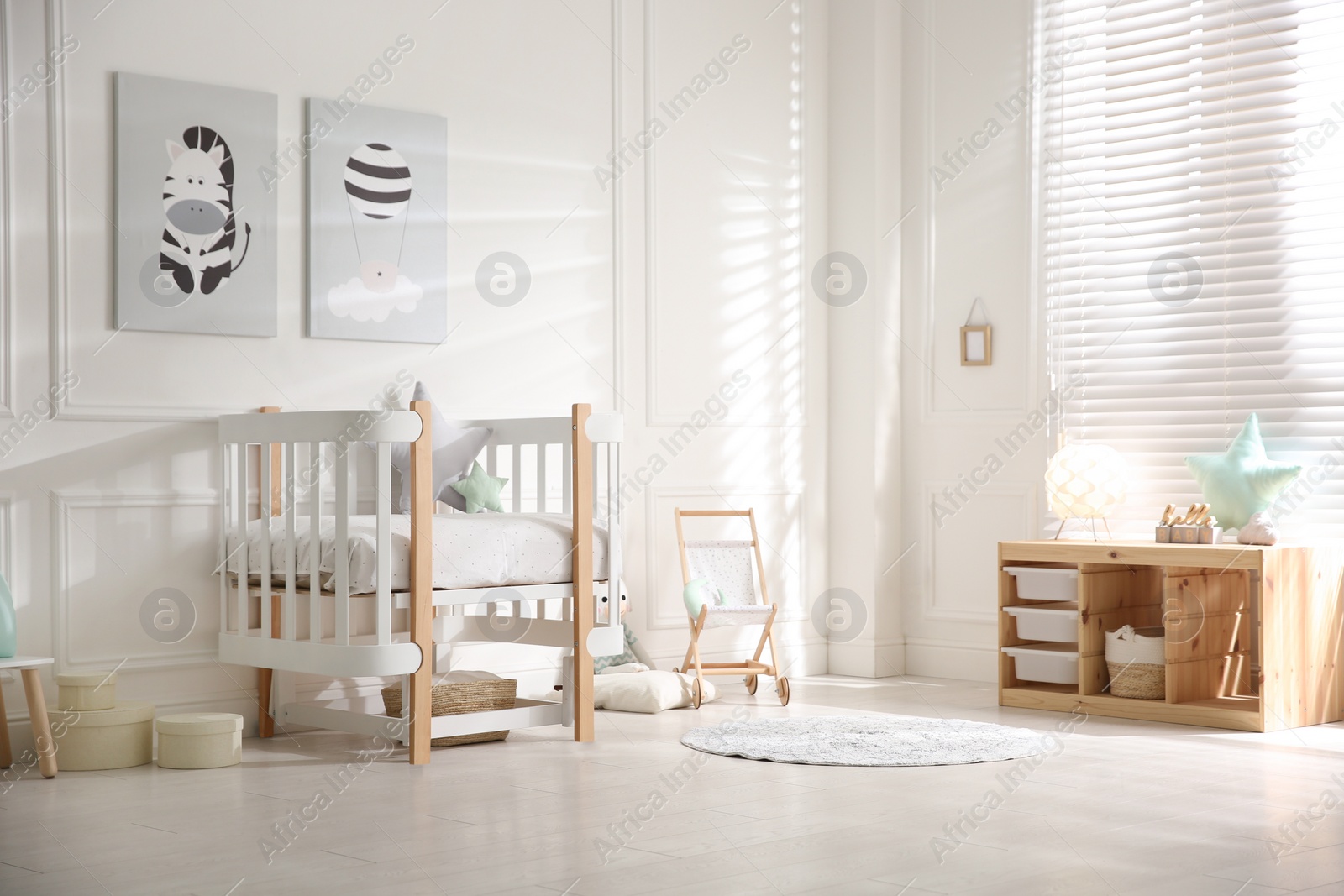 Photo of Baby room interior with stylish furniture and toys