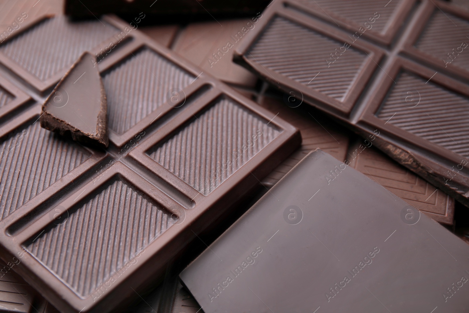 Photo of Many tasty chocolate bars as background, closeup