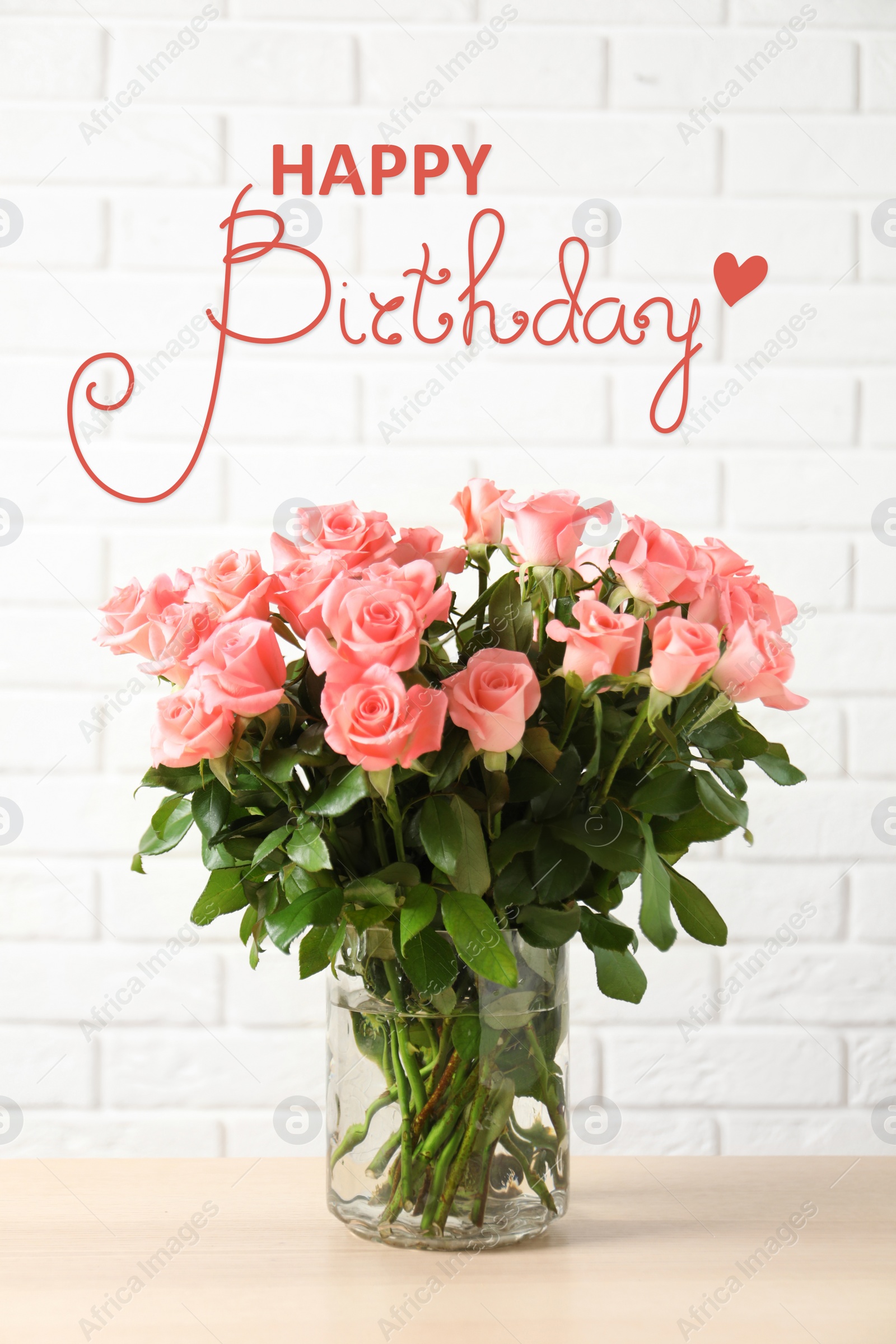 Image of Happy Birthday! Vase with beautiful rose flowers on table near white brick wall  