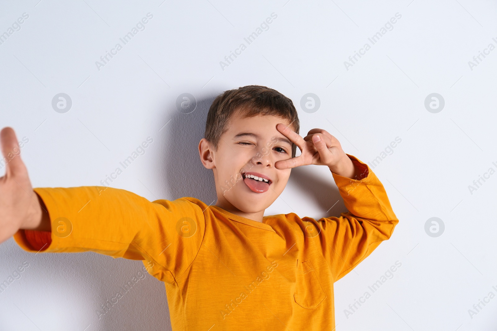 Photo of Portrait of cute little boy on light background