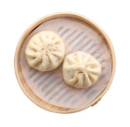 Delicious bao buns (baozi) in bamboo steamer isolated on white, top view