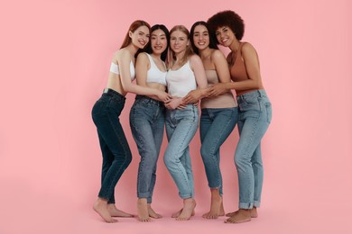 Group of beautiful young women on pink background