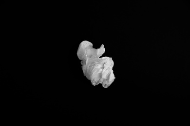 Used paper tissue on black background, top view