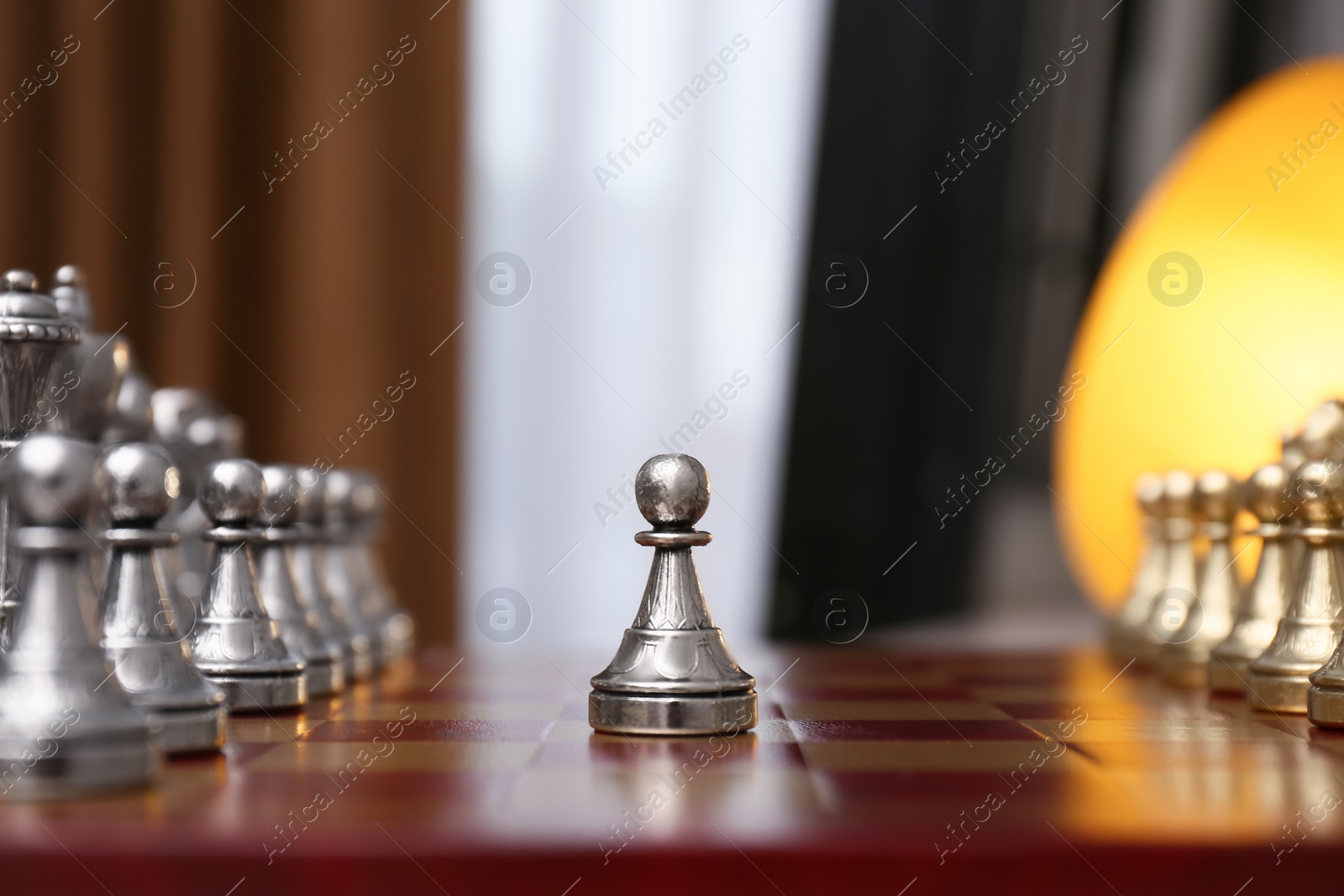 Photo of Pawn piece in middle of chessboard indoors
