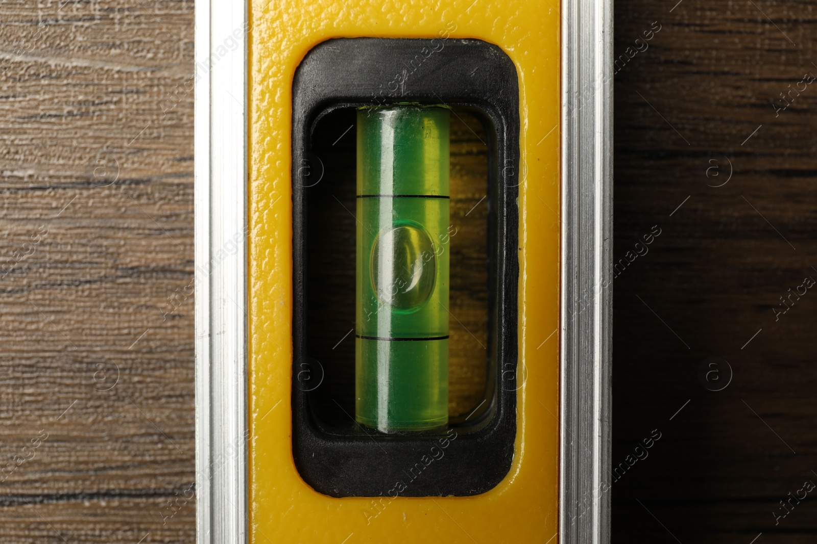 Photo of Building level on wooden table, top view