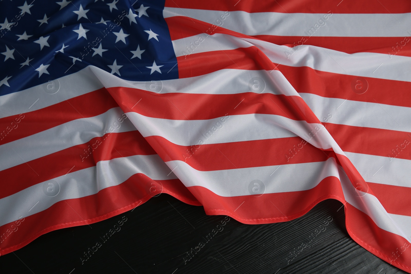 Photo of Flag of USA on black wooden table, top view