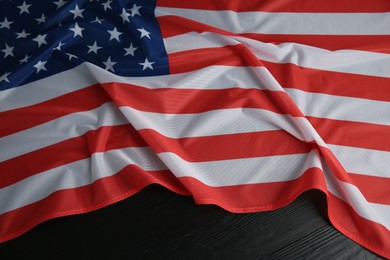 Flag of USA on black wooden table, top view