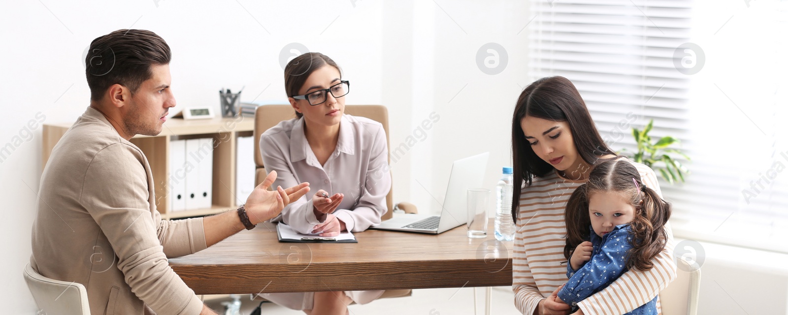 Image of Professional psychologist working with family in office