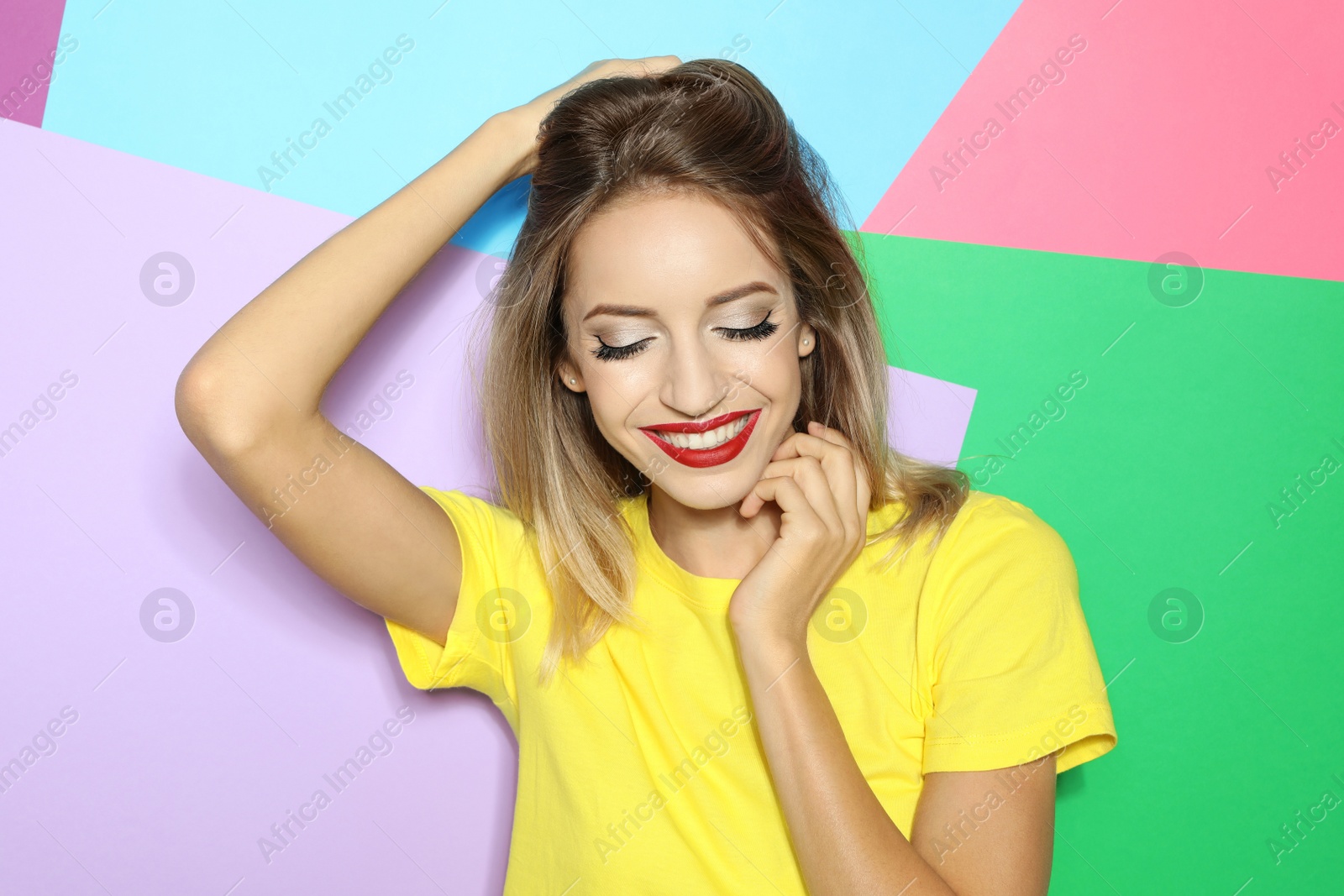 Photo of Beautiful young woman with healthy long blonde hair on color background