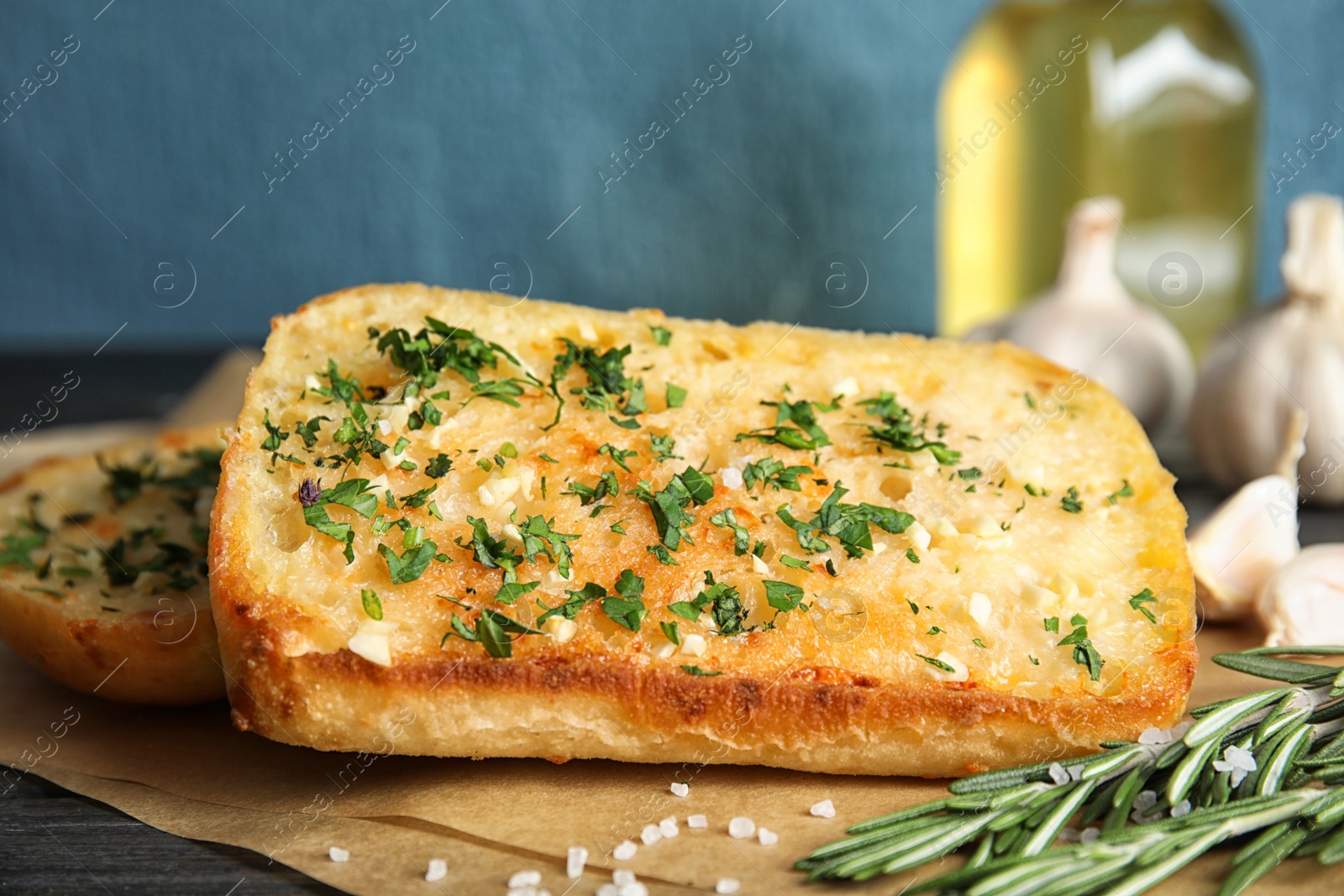 Photo of Tasty garlic bread with herbs on table