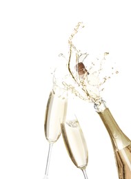 Sparkling wine splashing out of bottle and glasses on white background