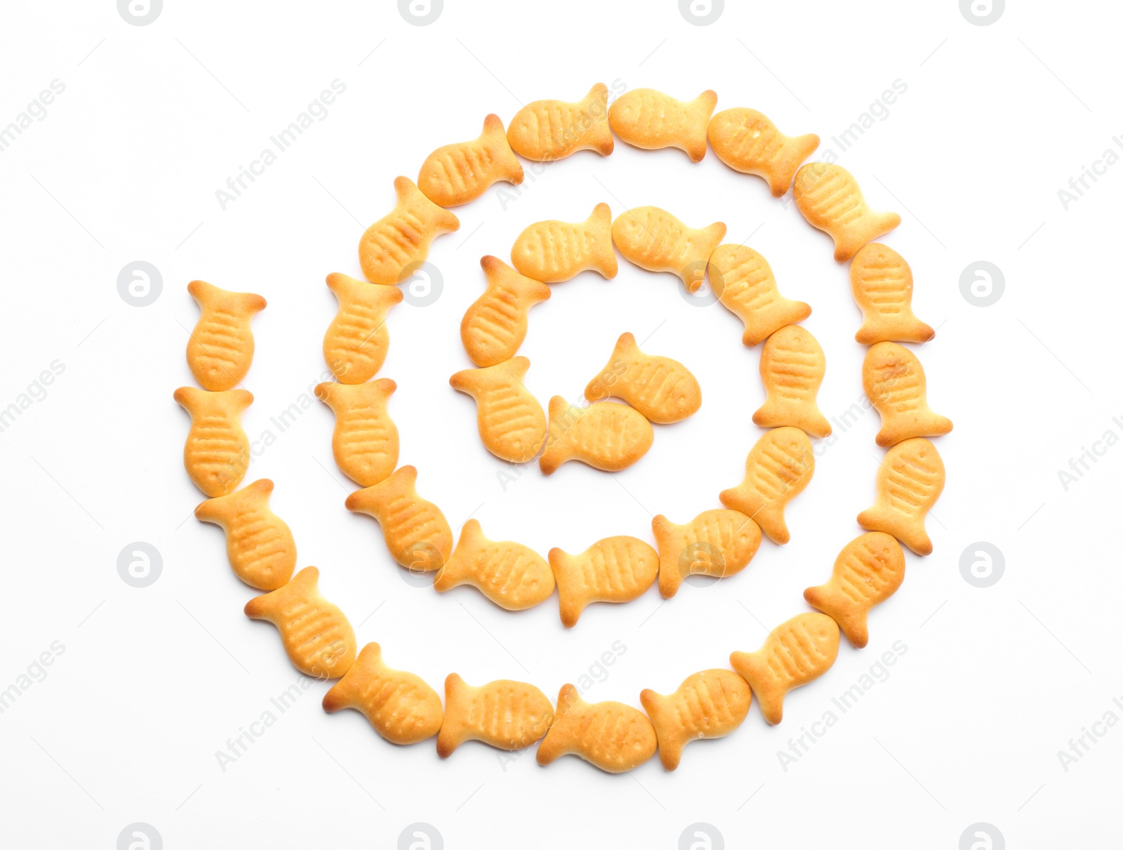 Photo of Delicious crispy goldfish crackers on white background, top view