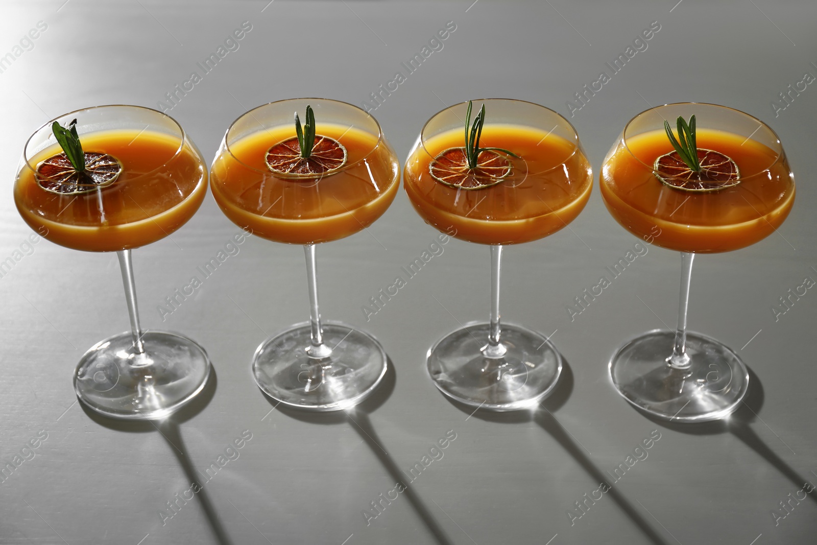 Photo of Glasses of delicious cocktail with vodka on table in bar