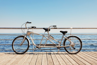 Photo of Tandem bike near sea on sunny day