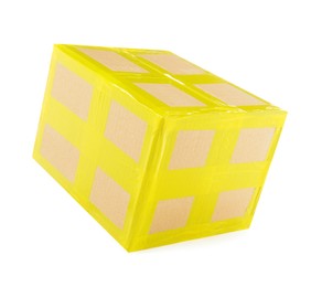 Cardboard parcel box with yellow sticky tape on white background