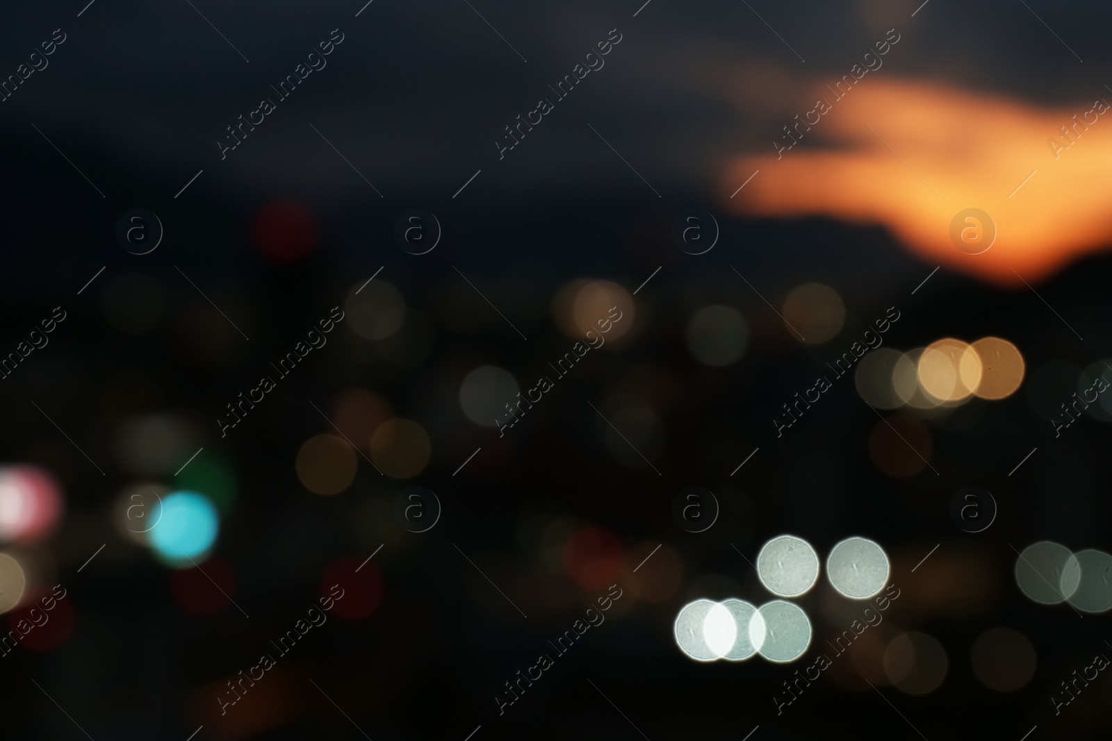 Photo of Blurred view of beautiful sunset with mountains in city, bokeh effect