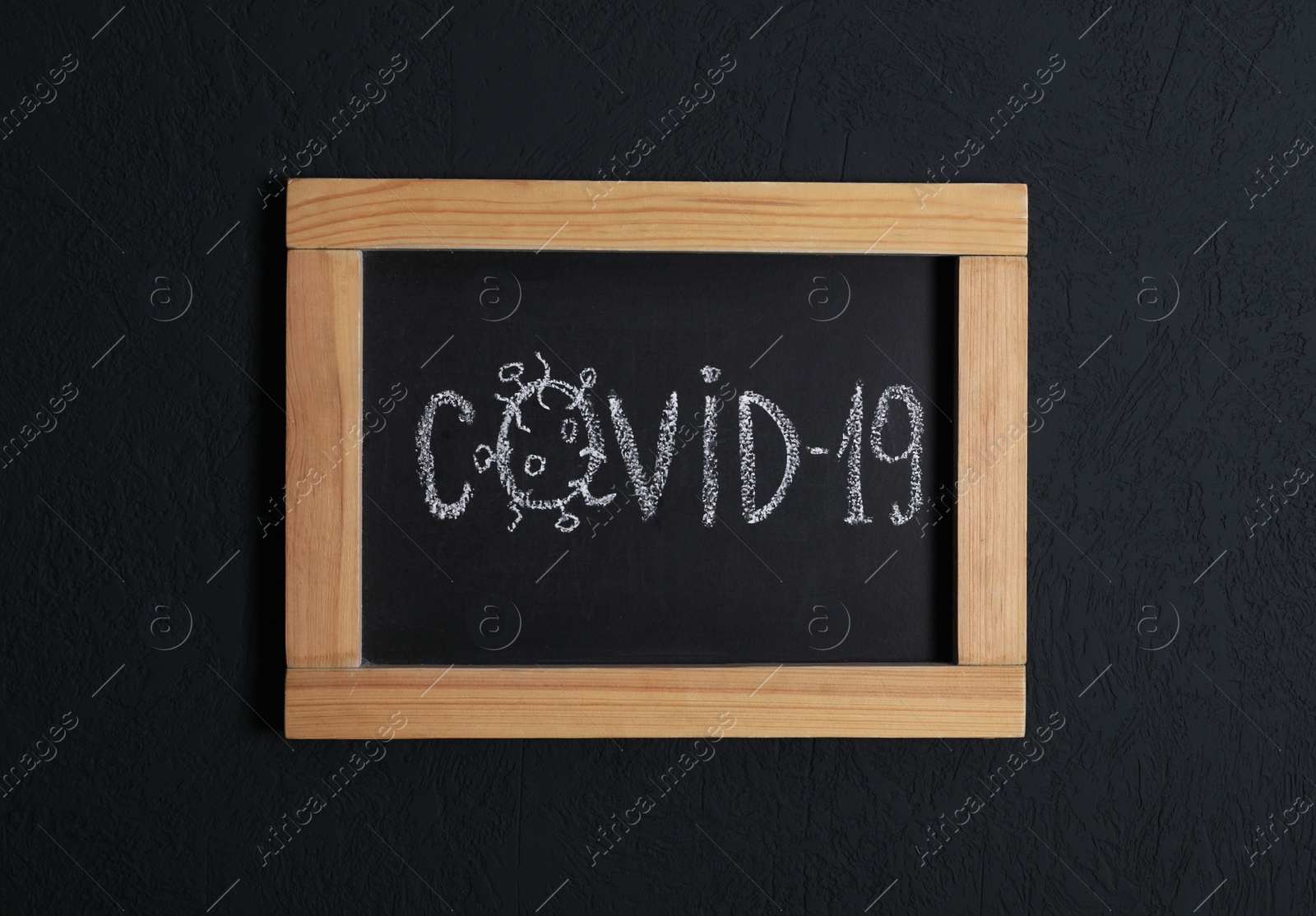 Photo of Blackboard with word Covid19 on black background, top view