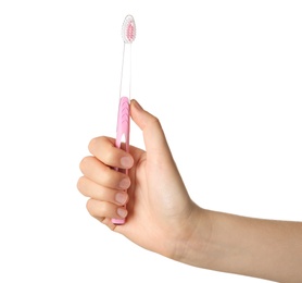 Photo of Woman holding manual toothbrush against white background