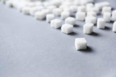 Refined sugar cubes on grey background