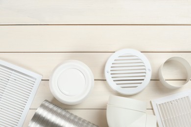 Parts of home ventilation system on white wooden surface, flat lay. Space for text