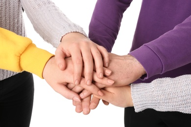 Group of people holding their hands together on white background, closeup