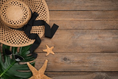 Flat lay composition with beach objects on wooden background, space for text