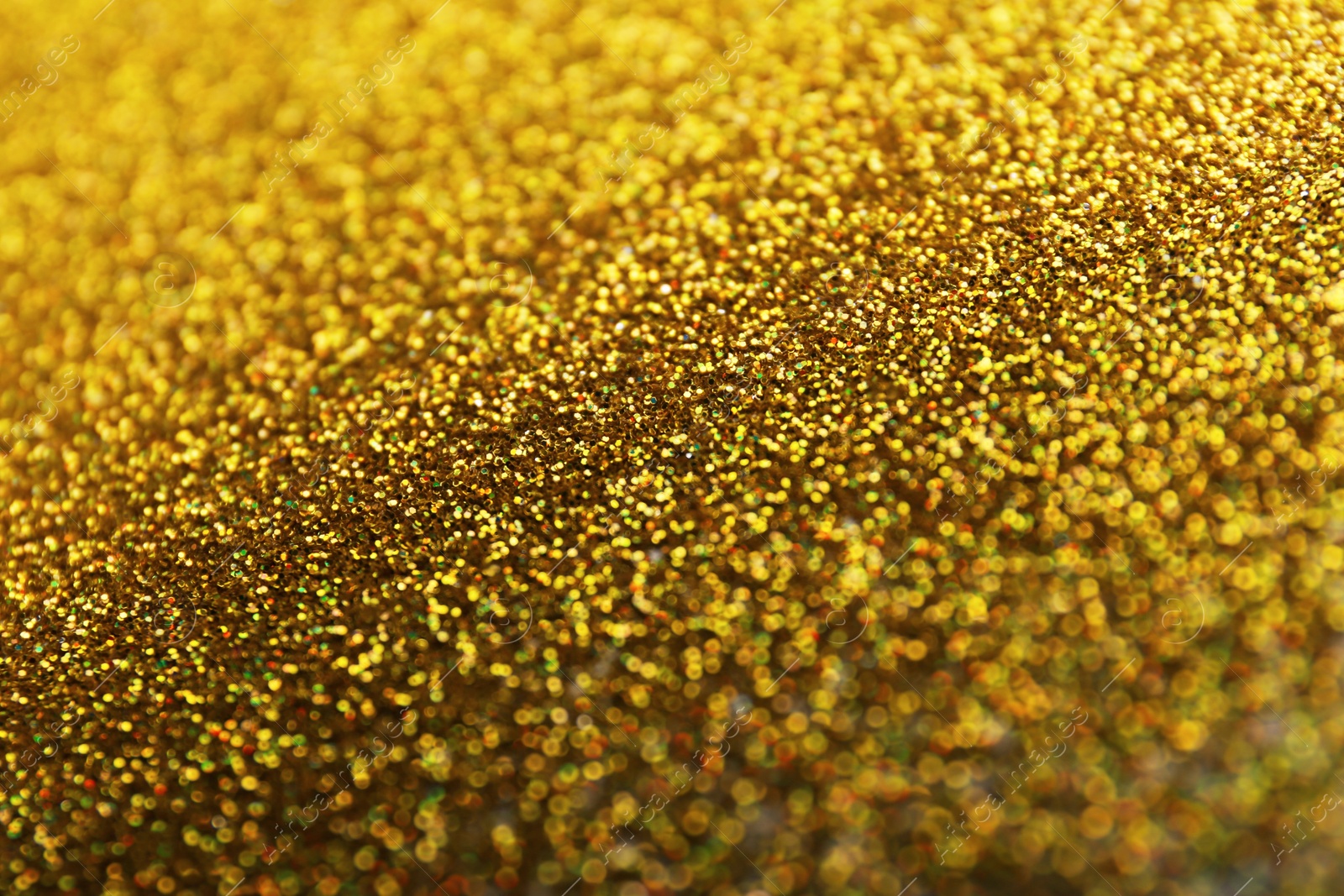 Photo of Closeup view of sparkling golden glitter background