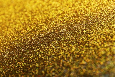 Photo of Closeup view of sparkling golden glitter background