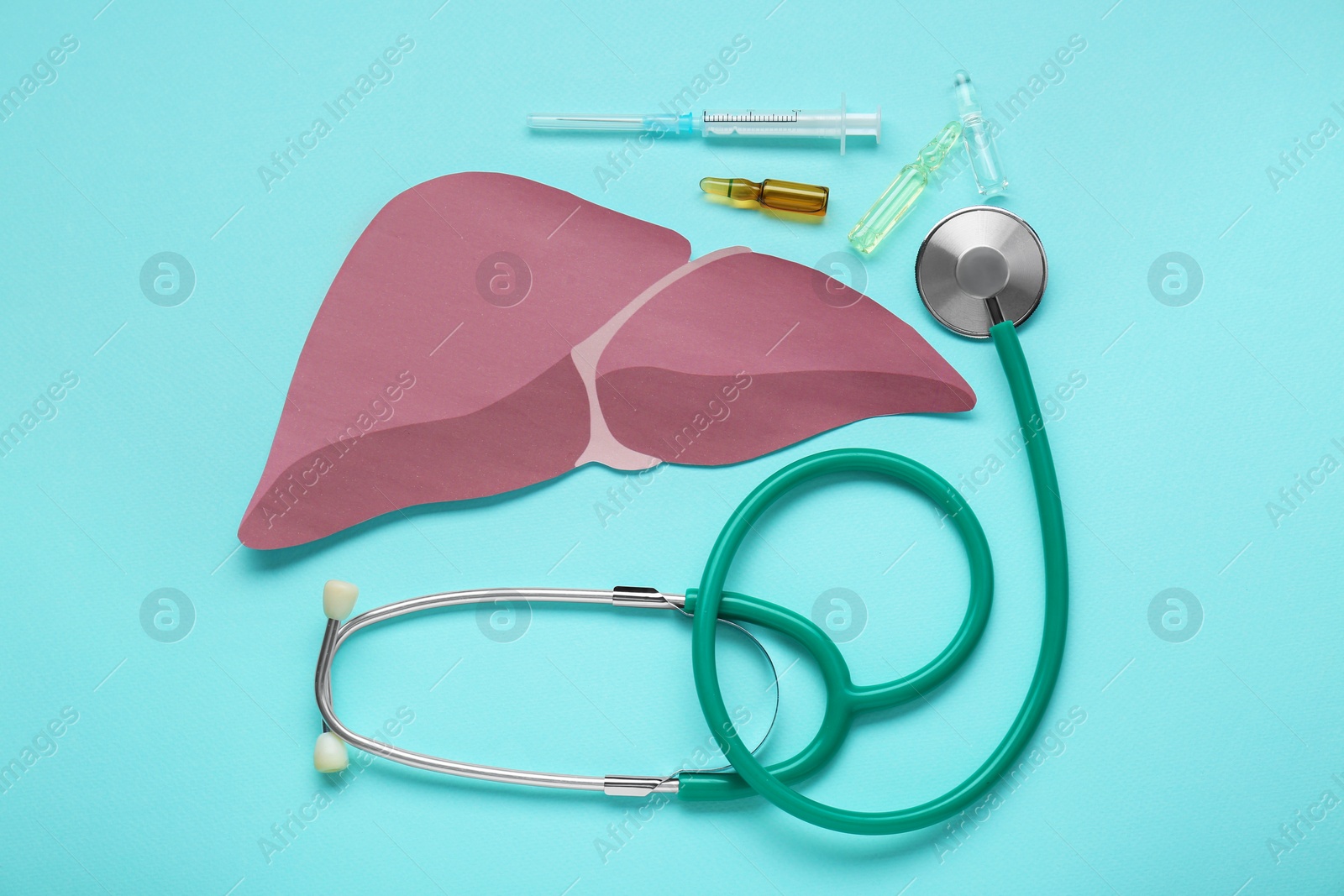 Photo of Paper liver, stethoscope, syringe and vials on turquoise background, flat lay. Hepatitis treatment