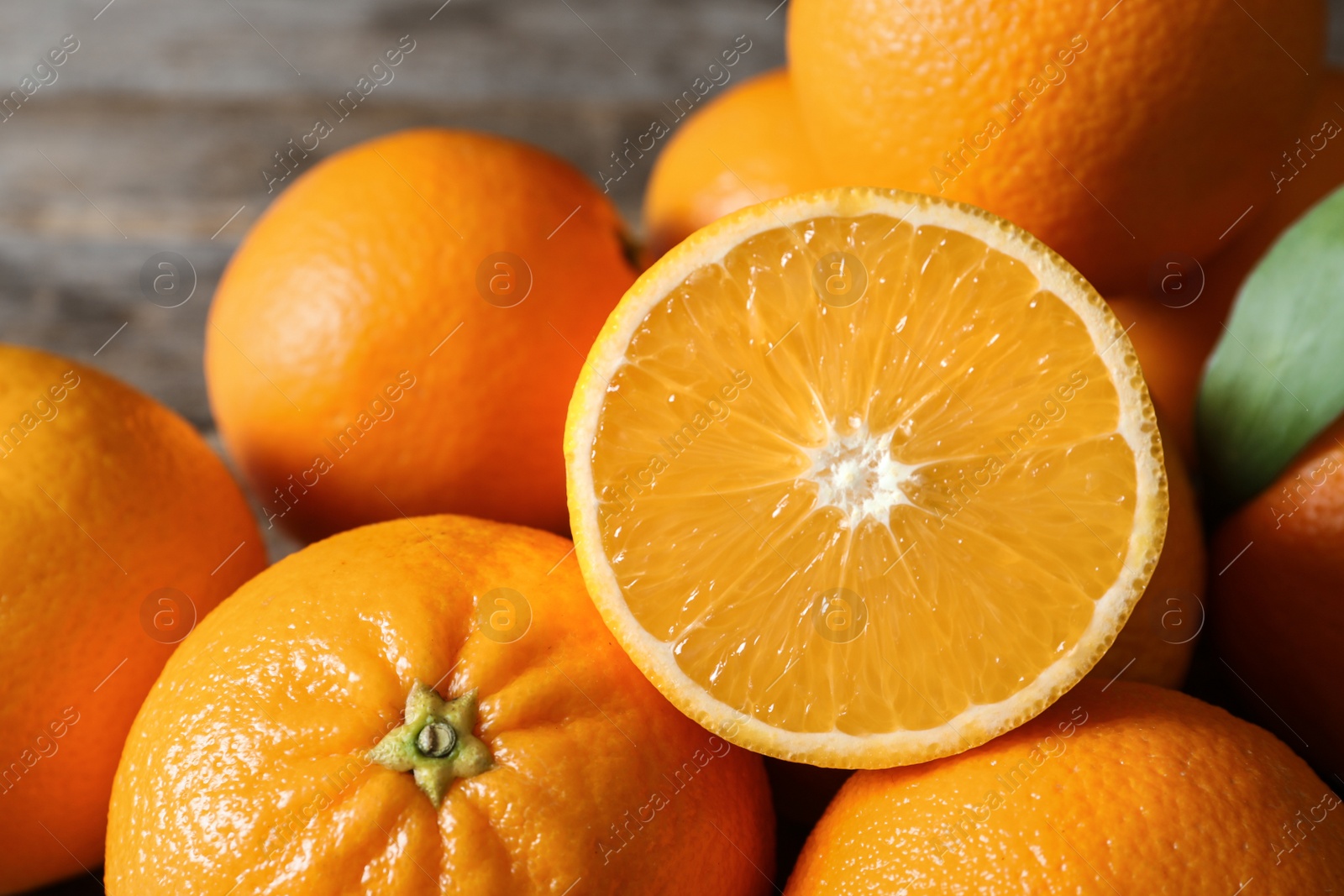 Photo of Fresh oranges on blurred background, closeup. Healthy fruits