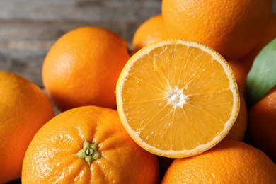 Photo of Fresh oranges on blurred background, closeup. Healthy fruits