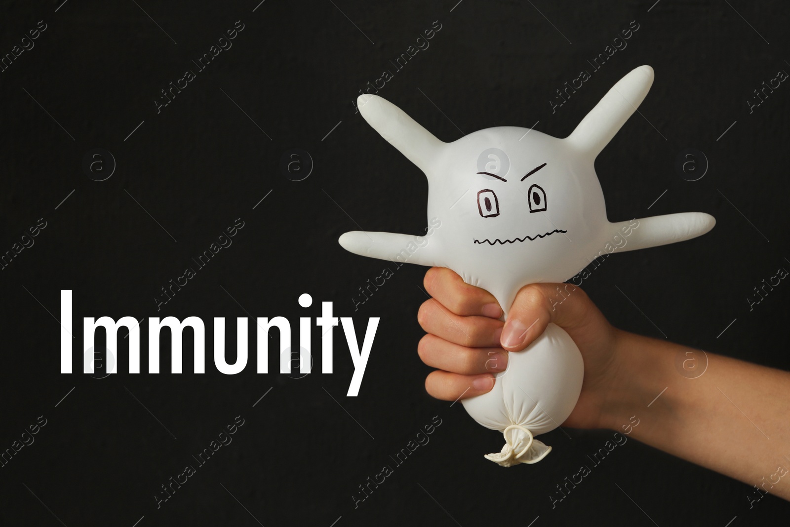 Photo of Woman squeezing glove monster on black background, closeup. Immune system concept