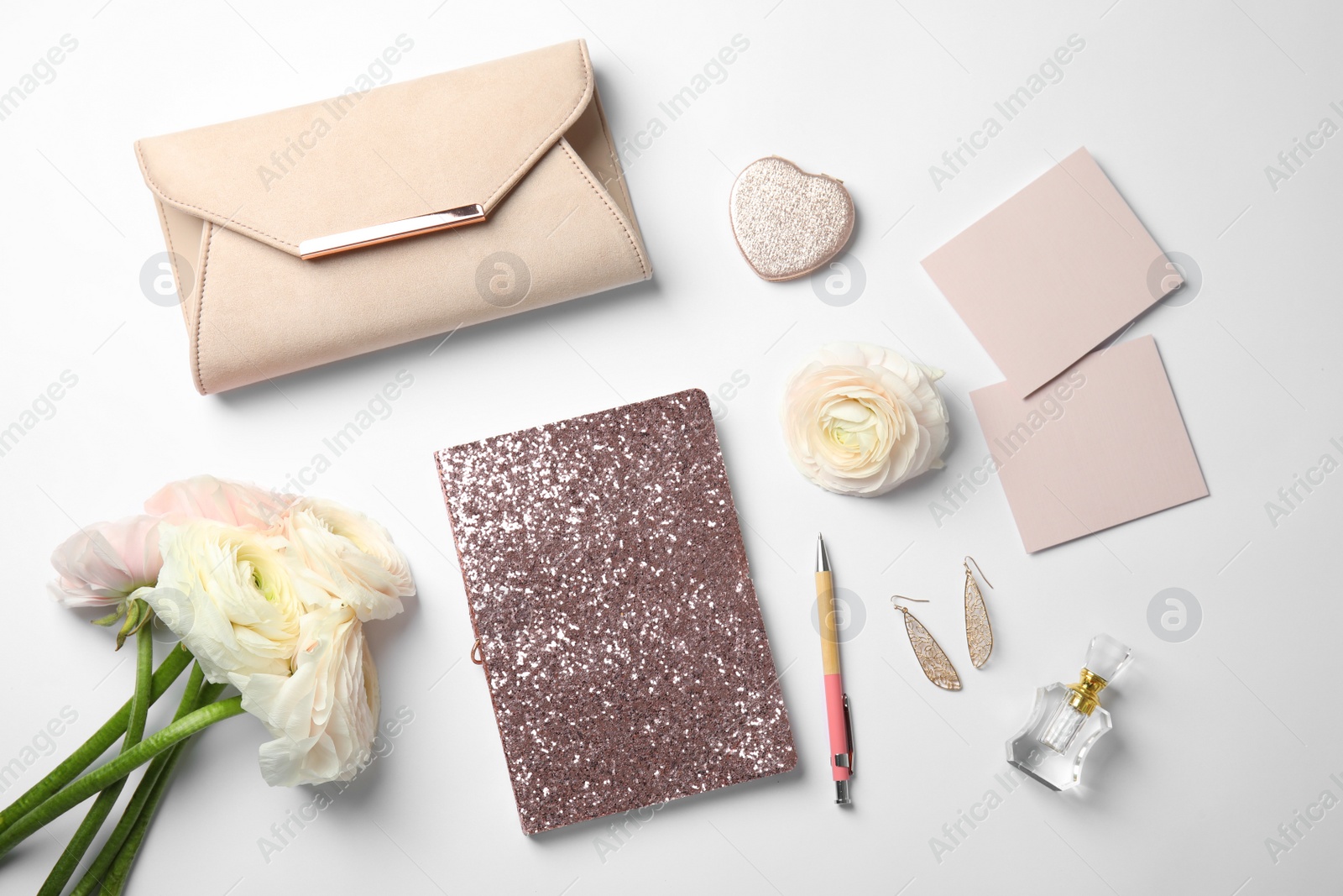 Photo of Flat lay composition with glittering notebook and spring flowers on white background