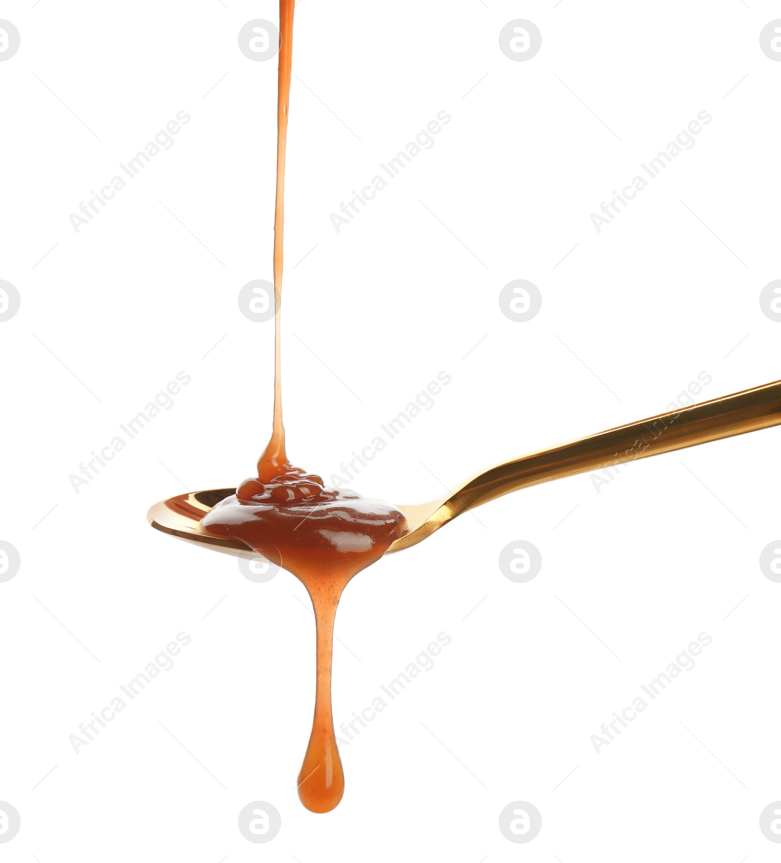 Photo of Tasty caramel sauce pouring into spoon isolated on white