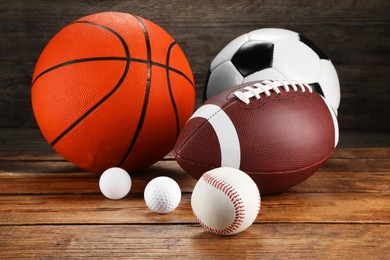 Photo of Many different sports balls on wooden background